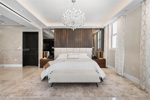 a spacious bedroom with a bed and a couch