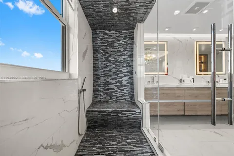 a living room with furniture and a mirror