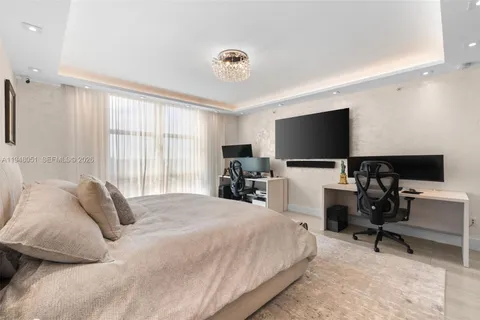 an aerial view of a tennis ground and a lots of palm trees