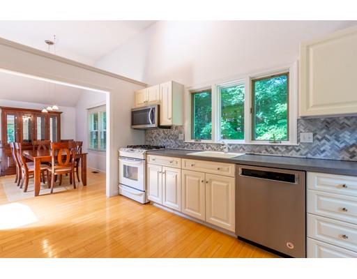 833 Edgell Road Framingham, MA 01701 - Photo 11 of 24 a kitchen with stainless steel appliances kitchen island granite countertop a stove a sink and a microwave