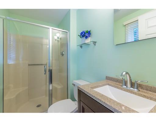833 Edgell Road Framingham, MA 01701 - Photo 14 of 24 a bathroom with a granite countertop sink a shower and a mirror