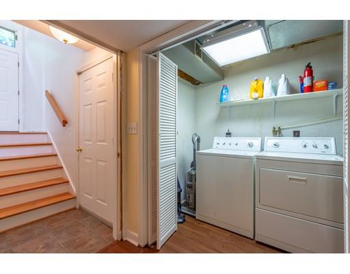 833 Edgell Road Framingham, MA 01701 - Photo 17 of 24 a utility room with cabinets dryer and washer
