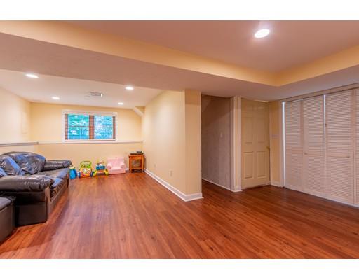 833 Edgell Road Framingham, MA 01701 - Photo 20 of 24 a view of a living room and kitchen with furniture wooden floor and windows