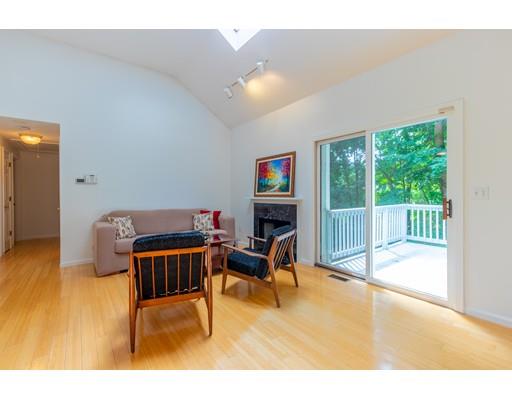 833 Edgell Road Framingham, MA 01701 - Photo 7 of 24 a living room with furniture a floor to ceiling window and a flat screen tv