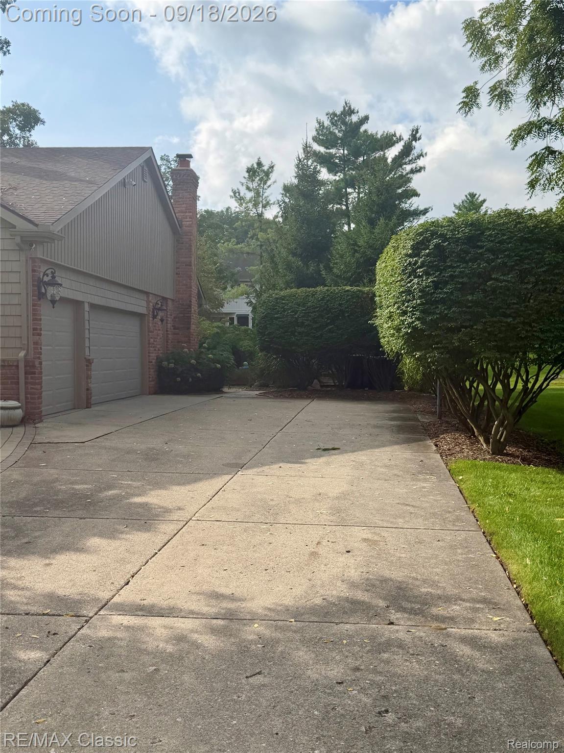 2899 Current Drive Rochester, MI 48309 - Photo 47 of 57 concrete driveway to 3 car garage and paver walkway to backyard