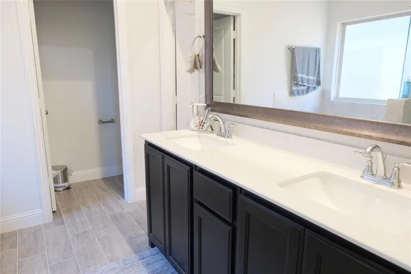 a bathroom with a sink double vanity and a mirror
