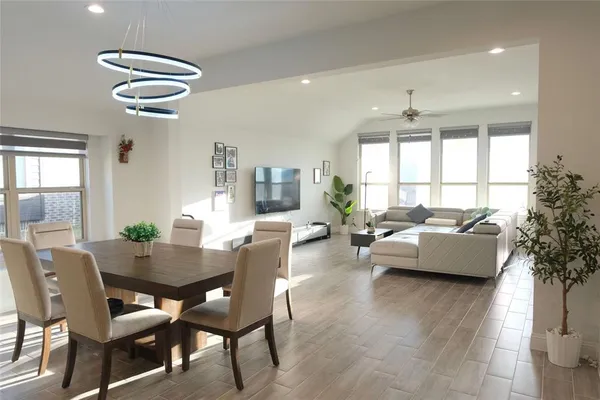 a view of a dining room with furniture and wooden floor