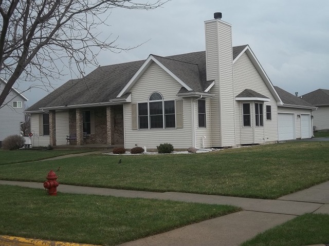 1232 Pickwick Drive Rochelle, IL 61068 - Photo 1 of 16 a front view of a house with a garden
