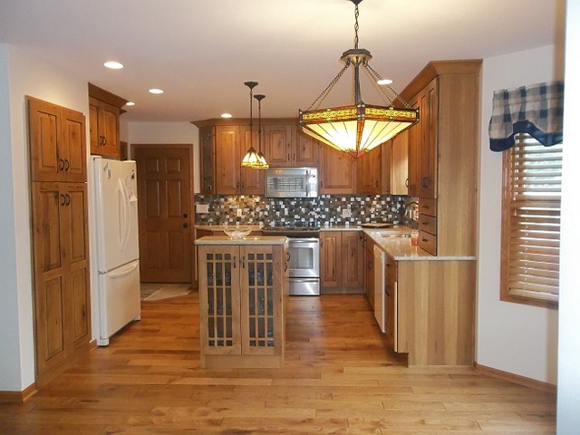1232 Pickwick Drive Rochelle, IL 61068 - Photo 6 of 16 a kitchen with stainless steel appliances kitchen island granite countertop a refrigerator a stove and a wooden floors