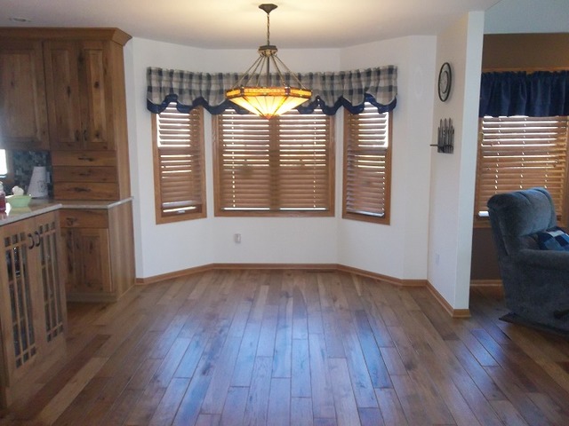1232 Pickwick Drive Rochelle, IL 61068 - Photo 8 of 16 a view of an empty room with wooden floor and a window