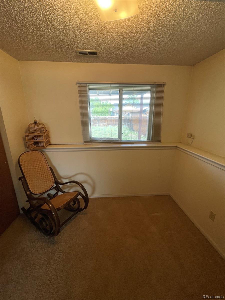 4841 Carson Street Denver, CO 80239 - Photo 10 of 12 a room with a window