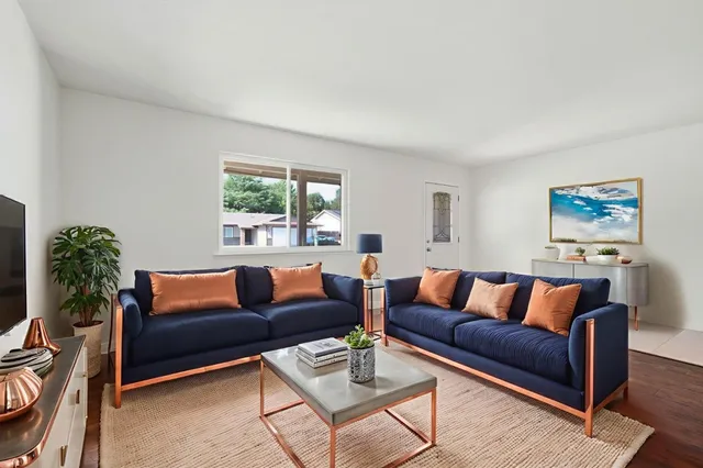 a living room with furniture lamp and a window