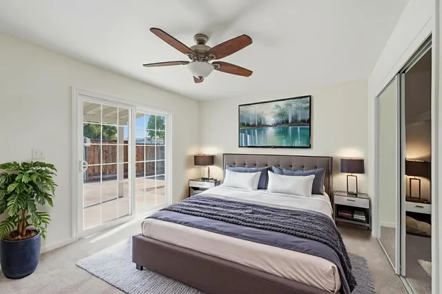 a bedroom with a large bed and a potted plant