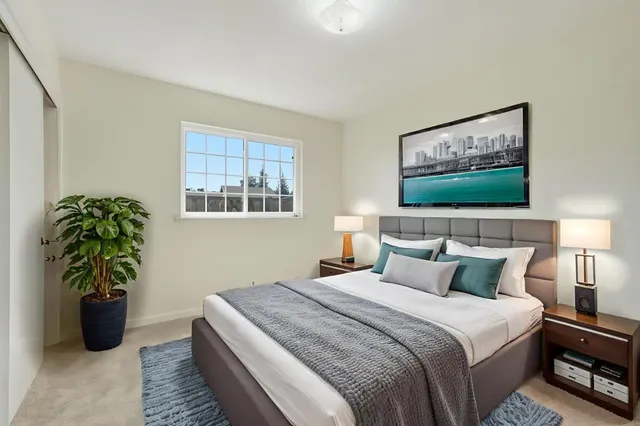 a bedroom with bed and a potted plant