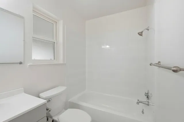 a white bath tub sitting next to a toilet