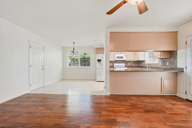 a view of a kitchen with a sink hardwood floor and a window