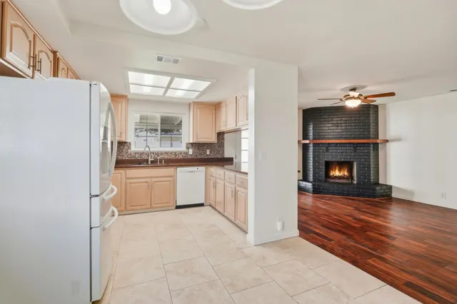 a kitchen with a refrigerator and a stove top oven