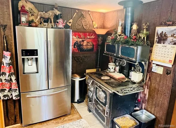 a living room with stainless steel appliances granite countertop furniture and a kitchen view