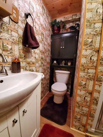 a view of a room with furniture and wooden floor