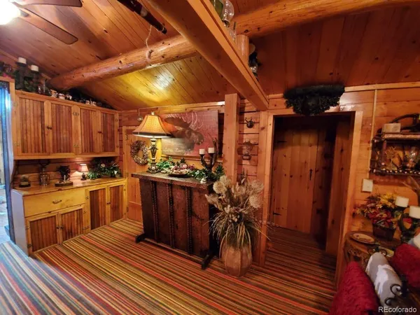 a kitchen with granite countertop a refrigerator and wooden floor