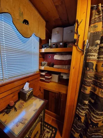 a bathroom with a granite countertop toilet and a shower curtain