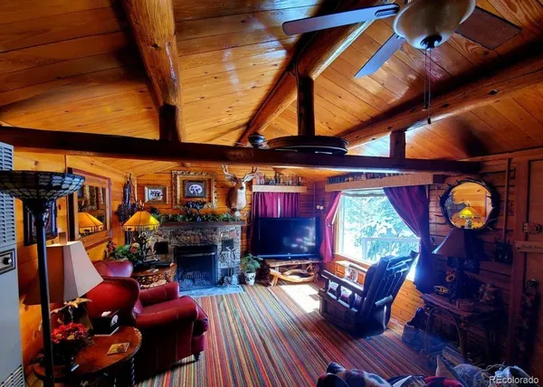 a view of a livingroom with furniture and a window