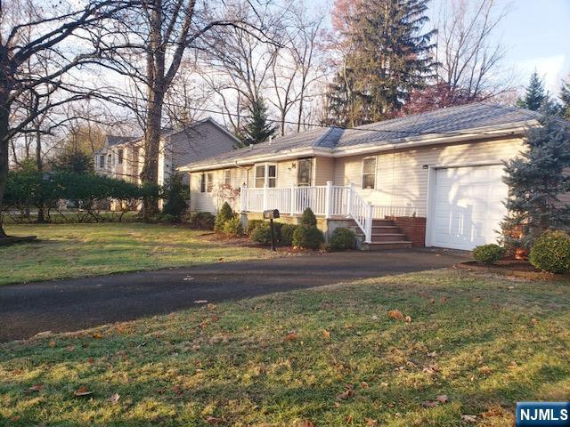 99 Knickerbocker Road Demarest, NJ 07627 - Photo 1 of 10 a view of a house with a big yard and large trees