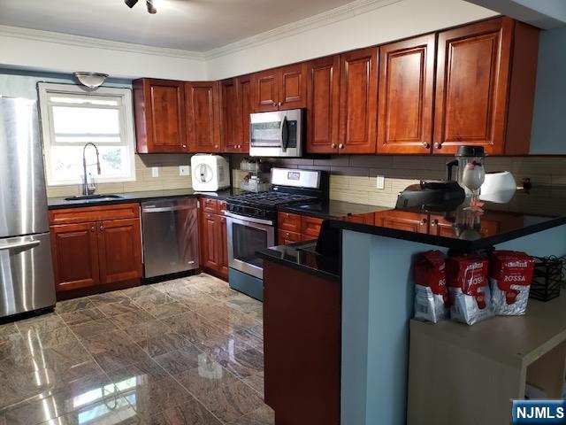 99 Knickerbocker Road Demarest, NJ 07627 - Photo 7 of 10 a kitchen with stainless steel appliances granite countertop wooden cabinets a stove top oven a sink and dishwasher