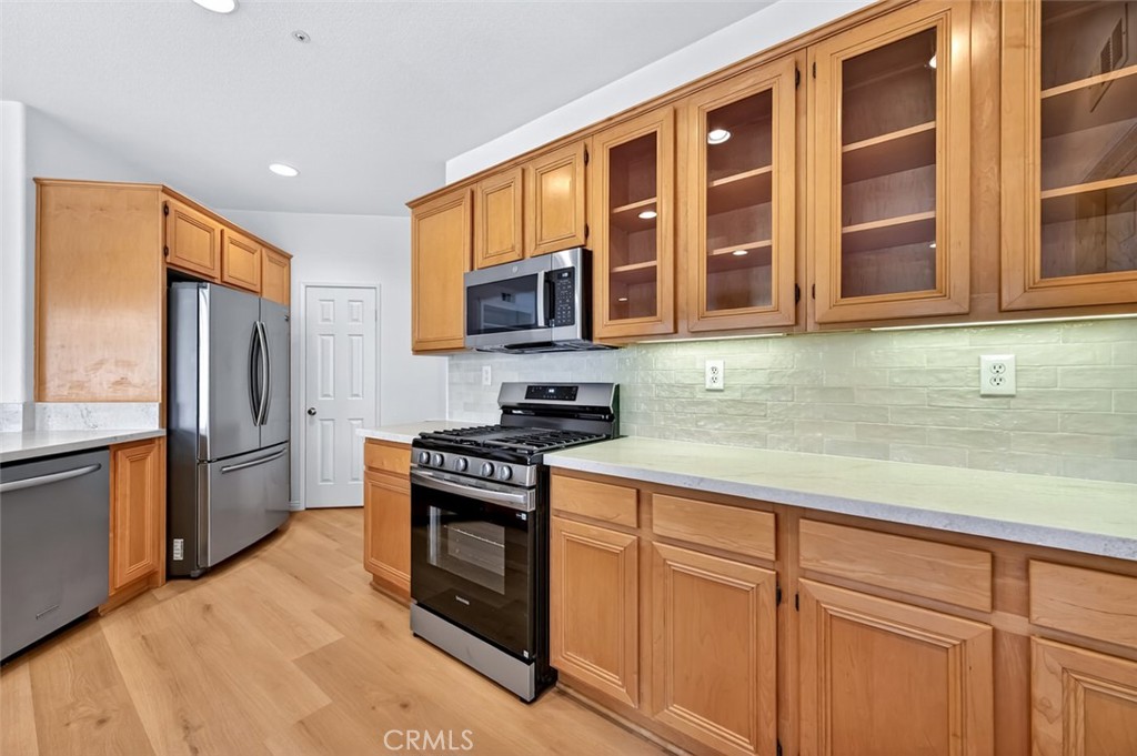 447 Ridgeway Irvine, CA 92620 - Photo 66 of 88 a kitchen with stainless steel appliances granite countertop a stove a sink dishwasher a refrigerator and cabinets with wooden floor