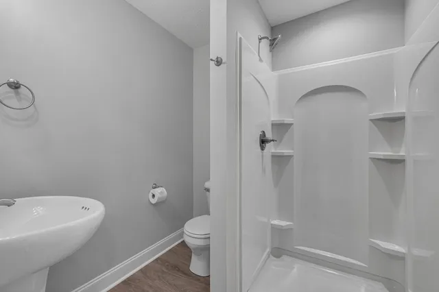a white bath tub sitting next to a white shower