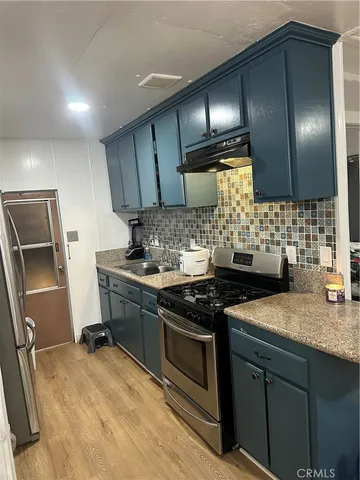 a kitchen with a stove and a sink