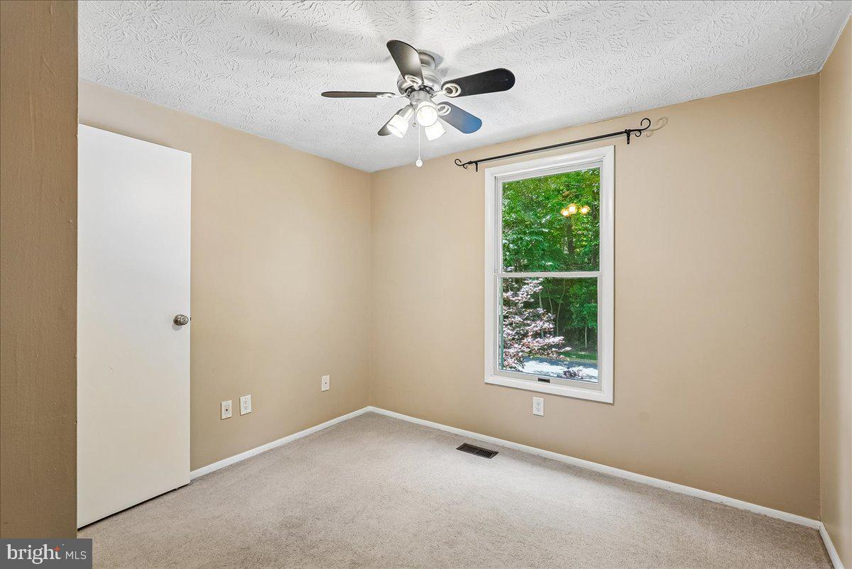 2331 Middle Creek Lane Reston, VA 20191 - Photo 33 of 78 an empty room with a window and a ceiling fan