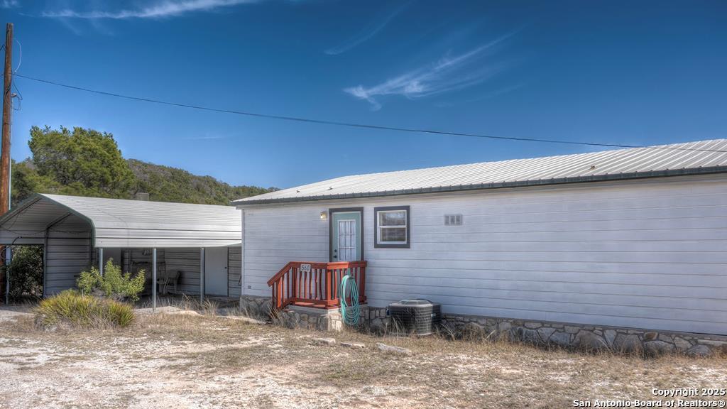 560 Pine Mountain Road Camp Wood, TX 78833 - Photo 1 of 38 a backyard of a house with yard and outdoor seating