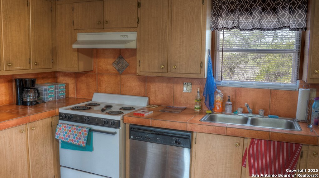 560 Pine Mountain Road Camp Wood, TX 78833 - Photo 12 of 38 a kitchen with stainless steel appliances granite countertop a sink stove and cabinets