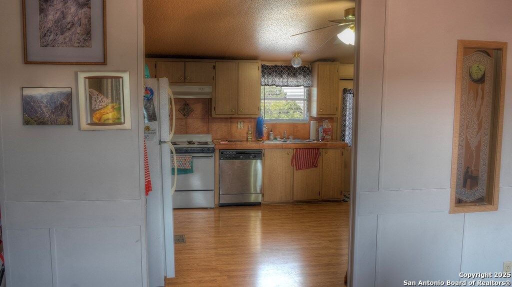 560 Pine Mountain Road Camp Wood, TX 78833 - Photo 16 of 38 a kitchen with stainless steel appliances granite countertop a refrigerator and a sink