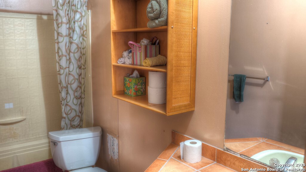 560 Pine Mountain Road Camp Wood, TX 78833 - Photo 20 of 38 a bathroom with a toilet and a shower curtain