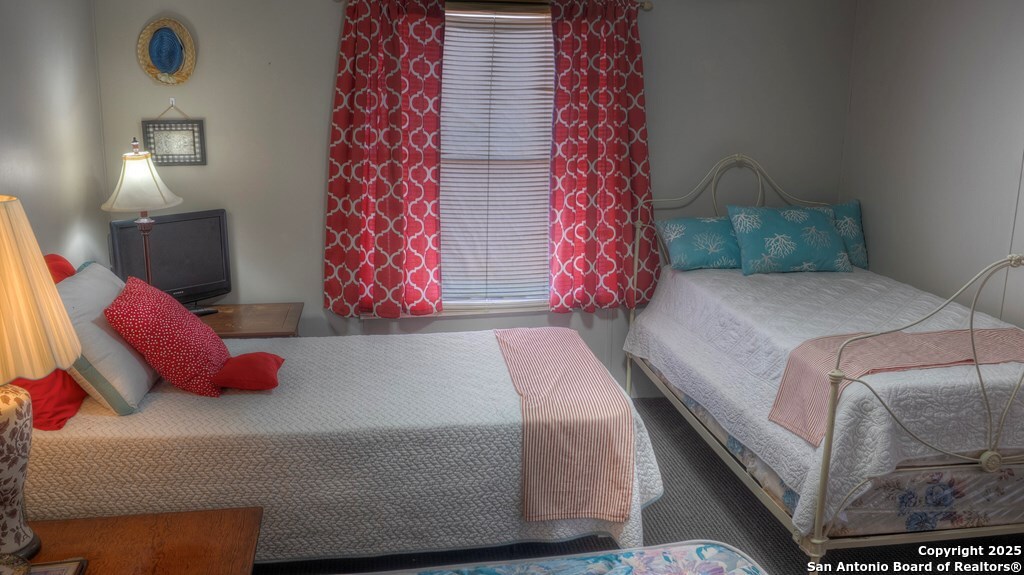 560 Pine Mountain Road Camp Wood, TX 78833 - Photo 22 of 38 a bedroom with a bed and a lamp