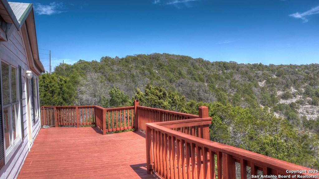560 Pine Mountain Road Camp Wood, TX 78833 - Photo 3 of 38 a balcony with wooden floor and city view