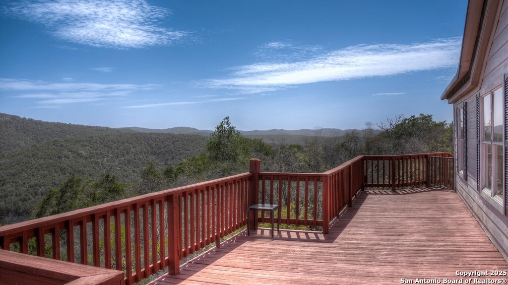 560 Pine Mountain Road Camp Wood, TX 78833 - Photo 4 of 38 a balcony with wooden floor and city view