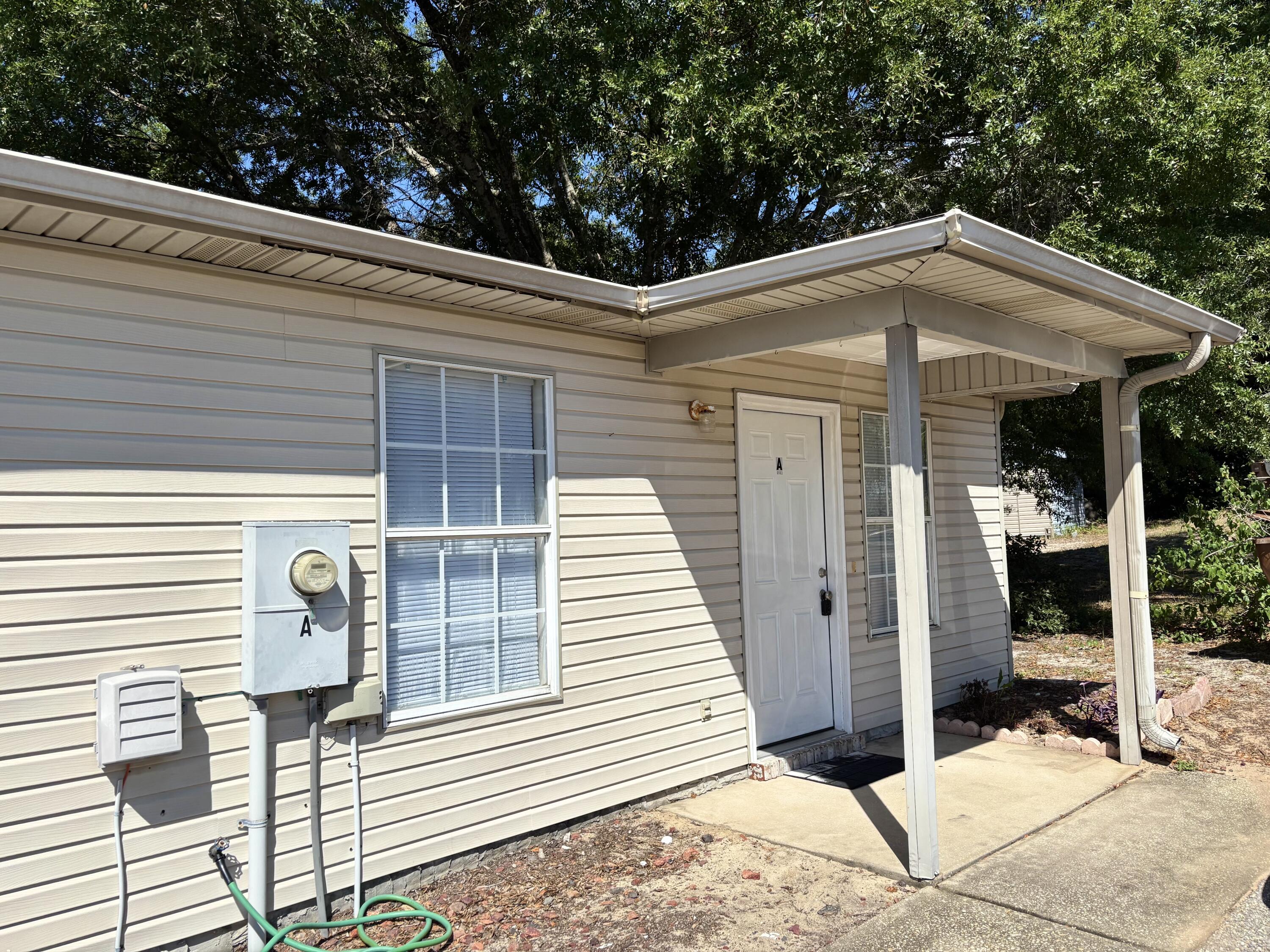 6903 Sea Turtle Circle, Unit A Navarre, FL 32566 - Photo 2 of 9 a front view of a house with entryway
