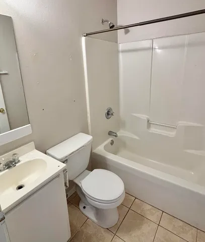 a bathroom with a toilet sink and shower
