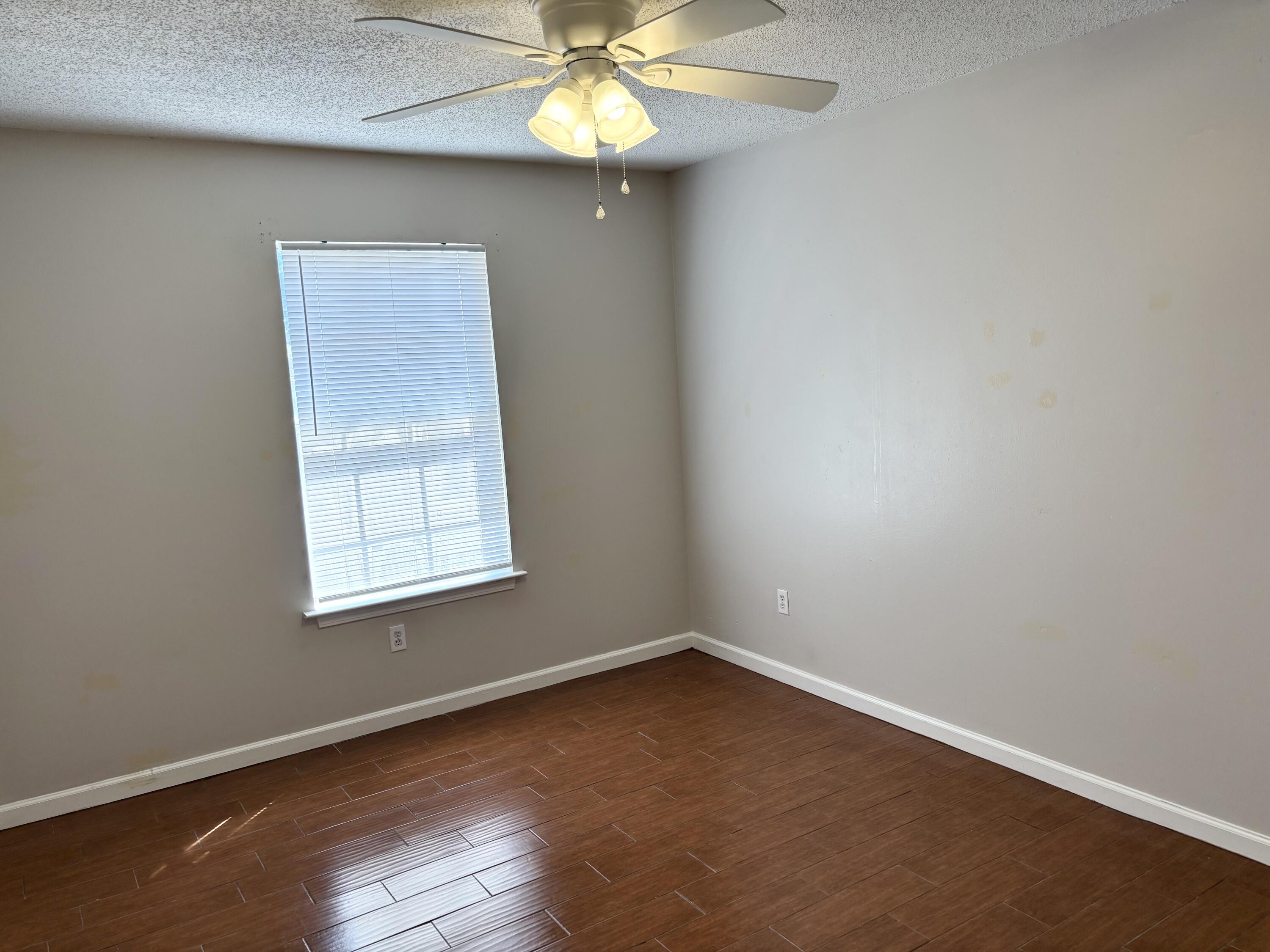 6903 Sea Turtle Circle, Unit A Navarre, FL 32566 - Photo 7 of 9 an empty room with a window and a fan