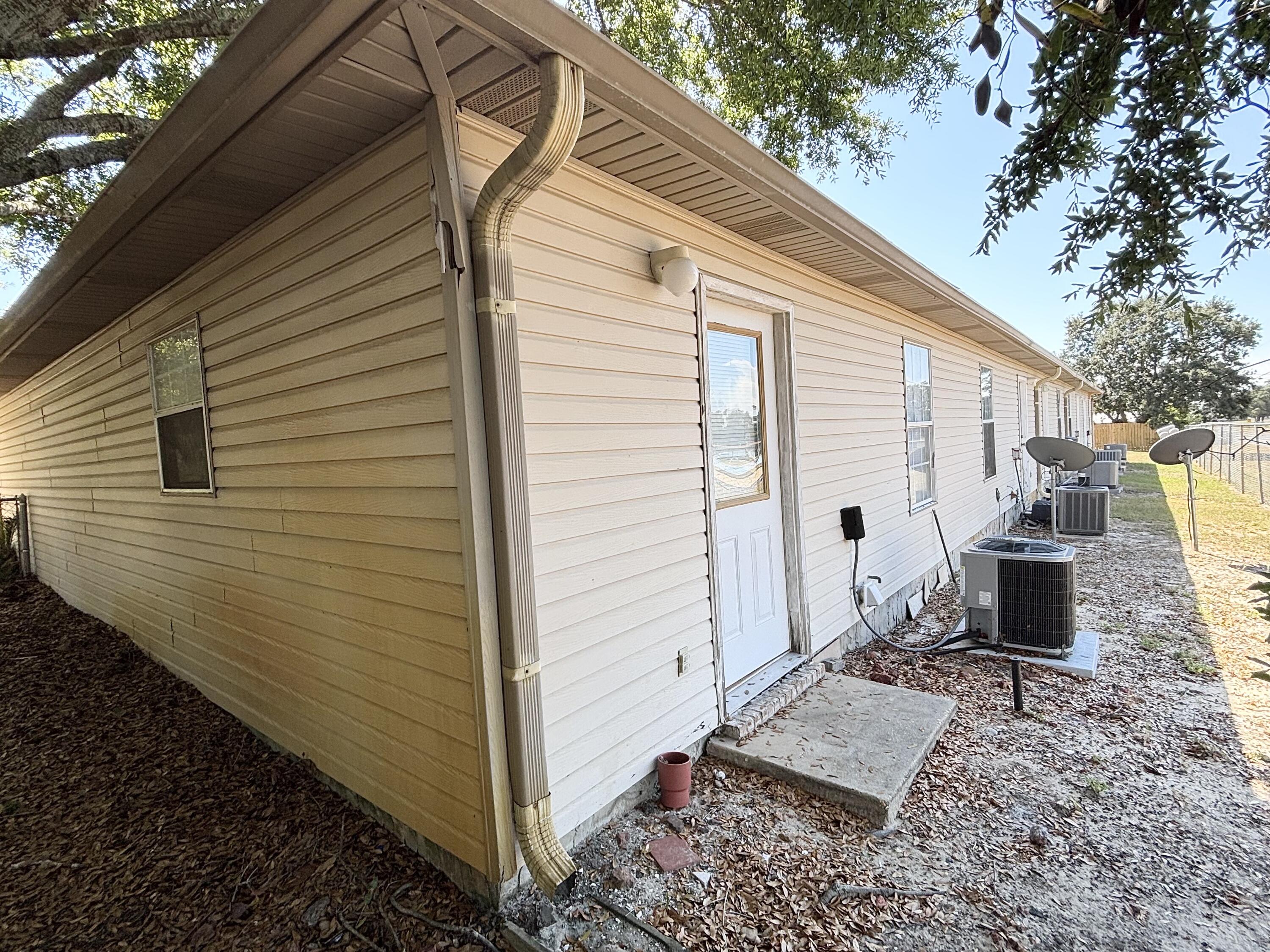 6903 Sea Turtle Circle, Unit A Navarre, FL 32566 - Photo 8 of 9 a view of backyard of house