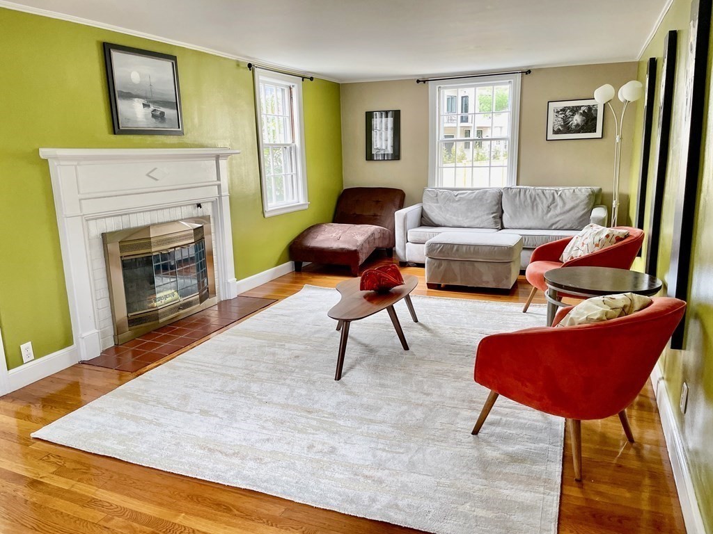 526 Quinobequin Road Newton, MA 02468 - Photo 13 of 42 a living room with furniture and a fireplace