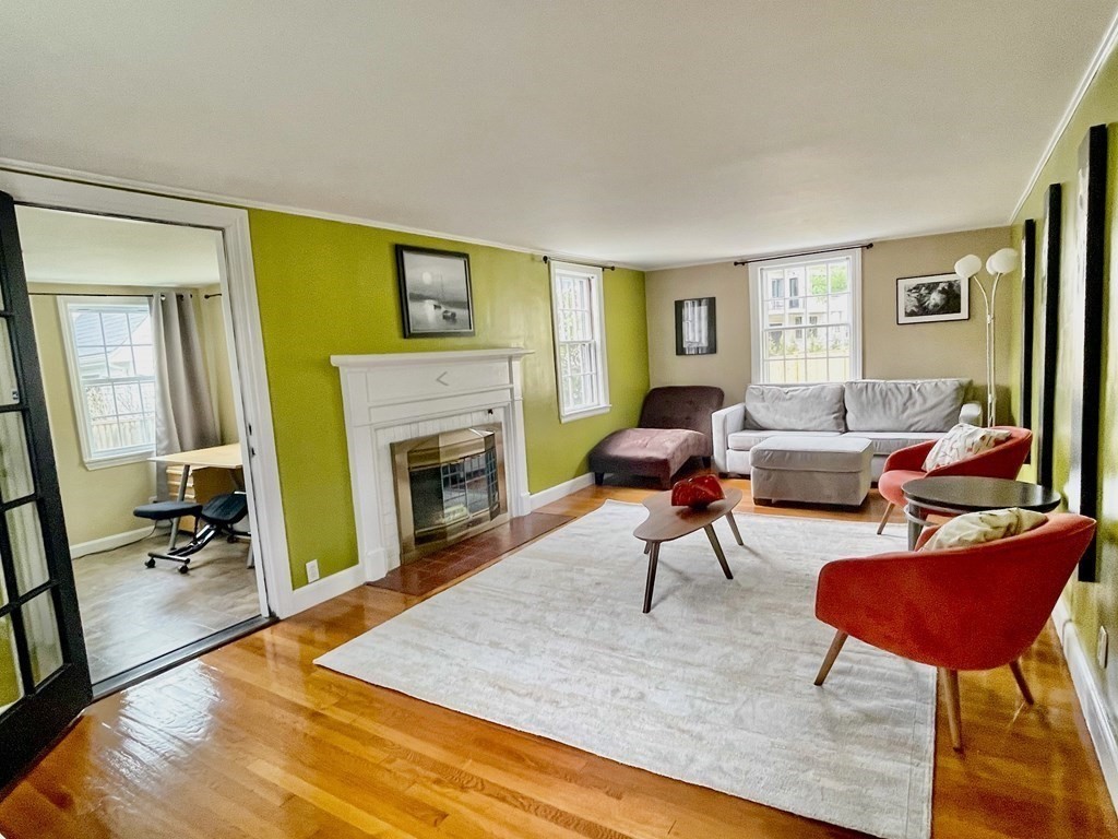 526 Quinobequin Road Newton, MA 02468 - Photo 14 of 42 a living room with furniture and a fireplace