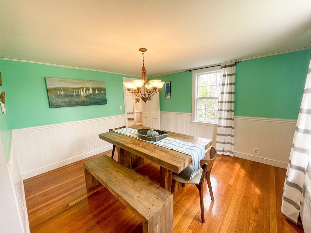 526 Quinobequin Road Newton, MA 02468 - Photo 18 of 42 a living room with a table and chairs with wooden floor