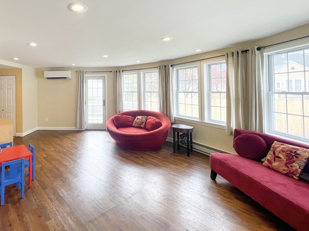 526 Quinobequin Road Newton, MA 02468 - Photo 26 of 42 a living room with furniture and a large window