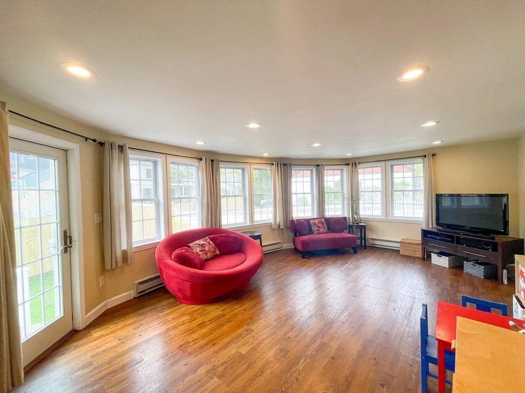526 Quinobequin Road Newton, MA 02468 - Photo 27 of 42 a living room with furniture and a flat screen tv