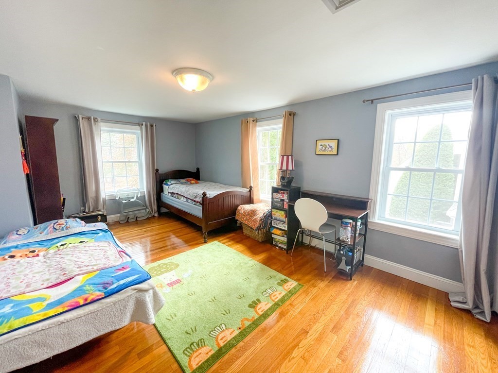 526 Quinobequin Road Newton, MA 02468 - Photo 28 of 42 a bedroom with a bed and a windows