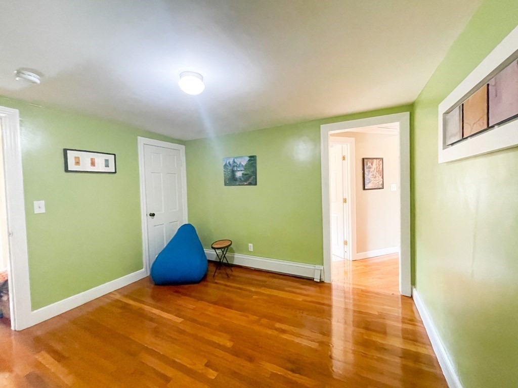526 Quinobequin Road Newton, MA 02468 - Photo 32 of 42 a view of empty room with wooden floor